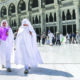 Women in Saudi Arabia walk through city.