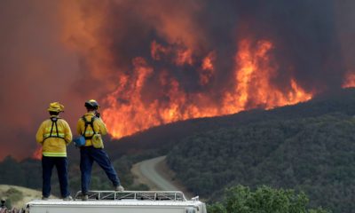 Photo of a fire crew keeping an eye on an advancing wildfire in SLO