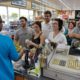 Photo of people lining up at a store to buy lottery tickets