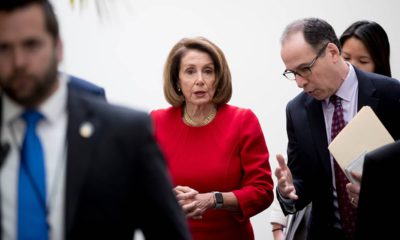 Photo of Nancy Pelosi leaving House Democratic caucus meeting