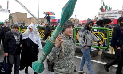Photo of teenager carrying a mock rocket propelled grenade