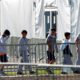 Photo of children lining up to enter a tent at the Homestead Temporary Shelter for Unaccompanied Children in Homestead, Fl.