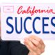 Photo of a woman holding a California license plate that says "Success"