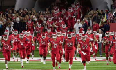 Photo of Fresno State football players running onto the field at Bulldog Stadium