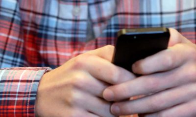 Photo of a person texting on their cellphone