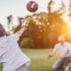 Photo of a son throwing a football to his dad