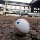 Photo of a baseball on packed dirt