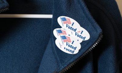Photo of a jacket with multiple "I Voted" stickers