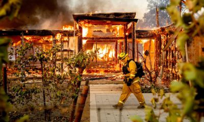 Photo of Woodbridge firefighter Joe Zurilgen passing a burning home