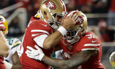 Photo of San Francisco 49ers running back Raheem Mostert and quarterback Jimmy Garoppolo