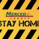 Merced County logo merged with Stay at Home order in black and yellow