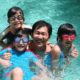 Photo of a dad with his children in a swimming pool on Father's Day