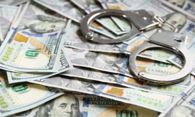 Photo of handcuffs and $100 bills signifying reward money for catching escapes inmates