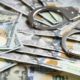 Photo of handcuffs and $100 bills signifying reward money for catching escapes inmates